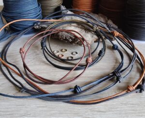 Rustic multi-color leather cords with adjustable knots for handmade necklaces and bracelets.