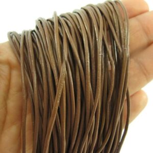 Brown genuine leather cords wrapped around a hand, showing flexible round leather strings for jewellery making and crafting.