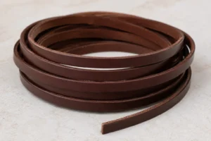 Brown flat leather cord coil.