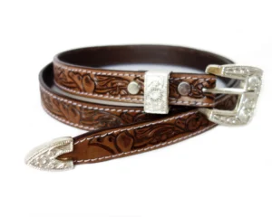 Hand-tooled brown leather belt with floral tooling and engraved silver buckle tip hardware.